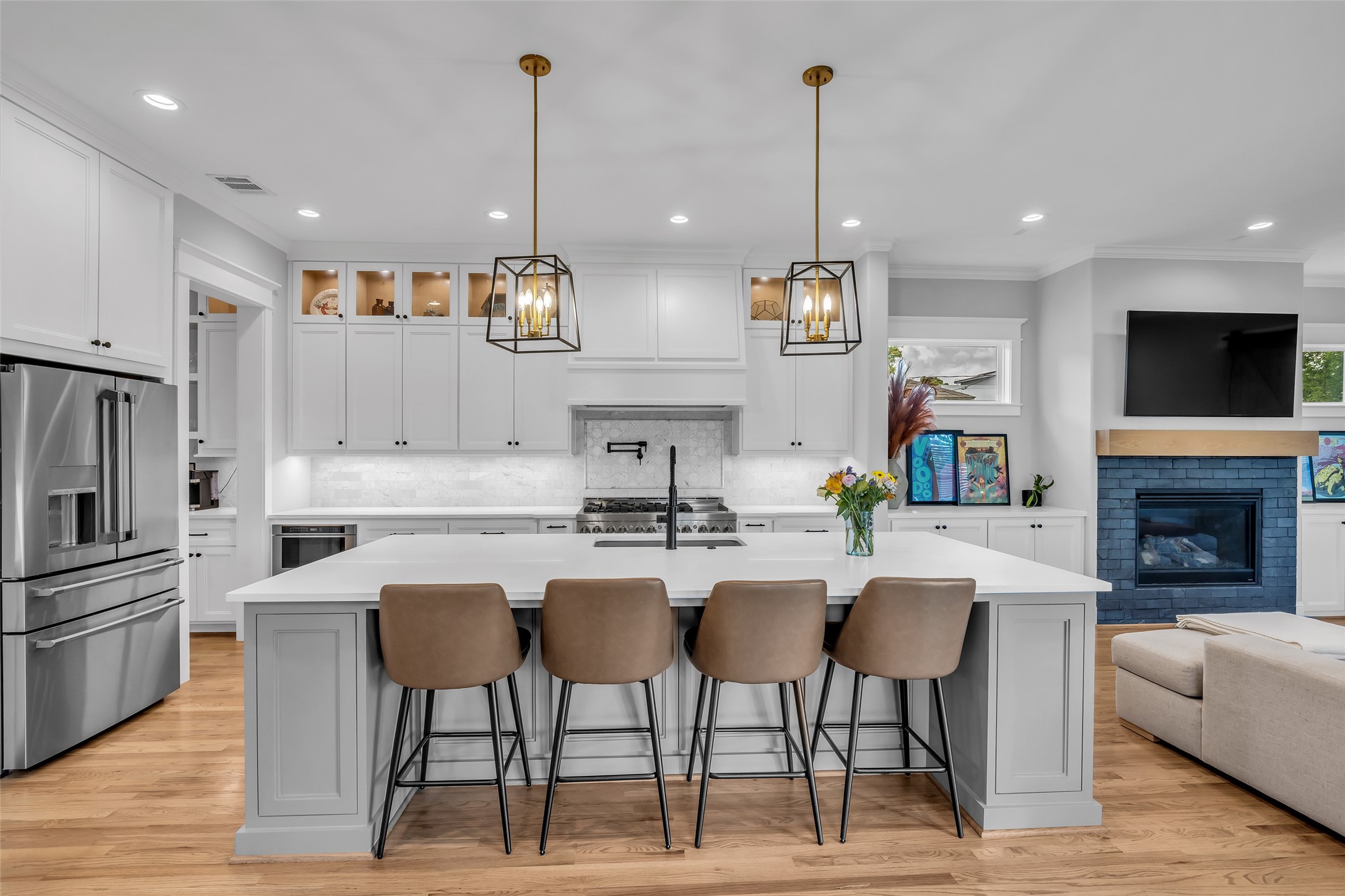 800 Walton Street Houston, TX 77009 - Photo 15 of 38 Full view of the kitchen highlights stylish droplights hanging above the island, adding both charm and focused lighting for meal prep and dining.