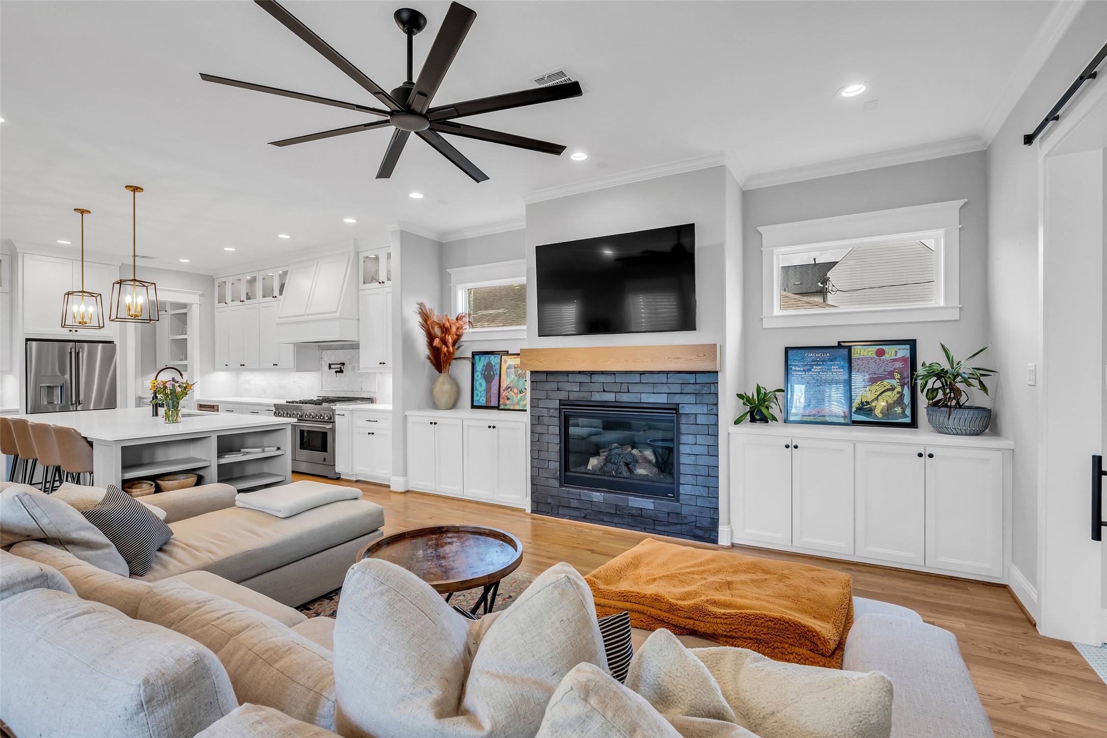 800 Walton Street Houston, TX 77009 - Photo 17 of 38 The living room, open to the kitchen, features a gas/log fireplace, creating a cozy focal point while maintaining a connected, open layout.