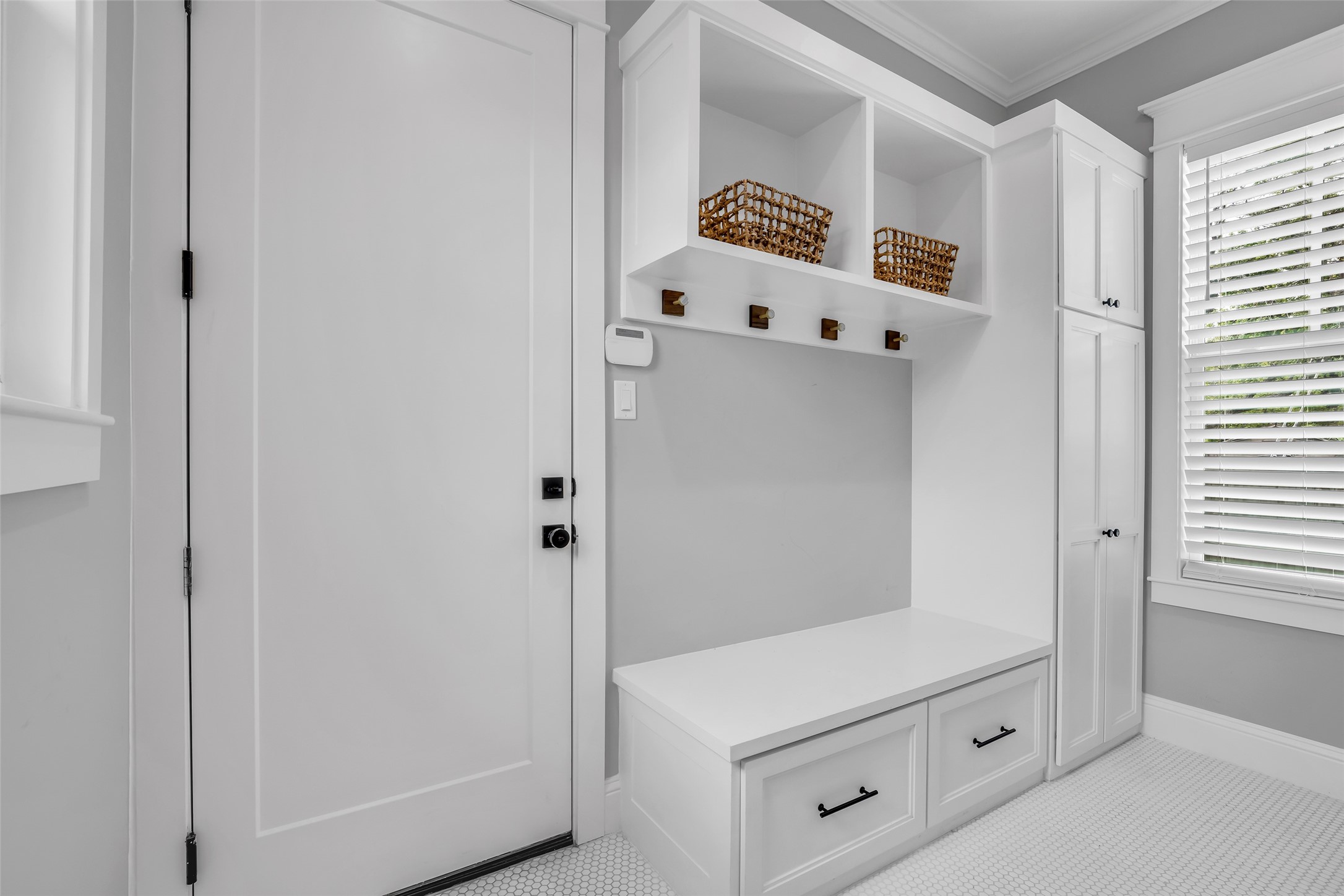 800 Walton Street Houston, TX 77009 - Photo 23 of 38 Hallway connecting the garage and living room includes extra storage space, adding convenience and organization to the home.