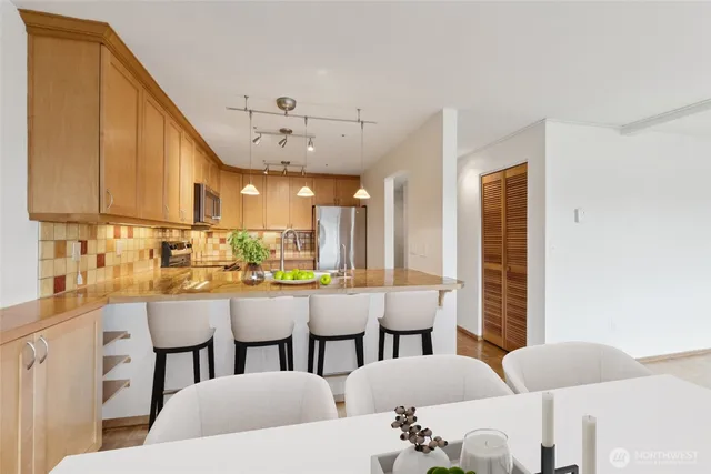 a large kitchen with a table and chairs