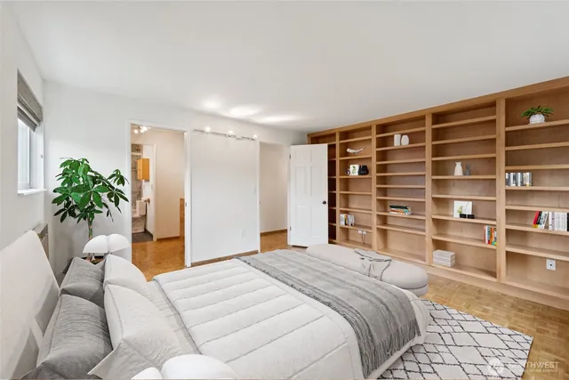 a bedroom with a bed and a potted plant