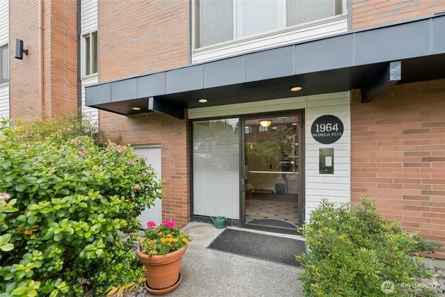 a front view of a house with potted plants
