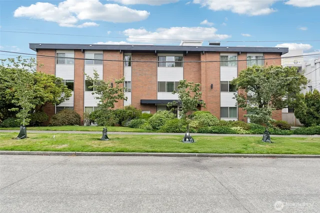 a front view of a house with a yard and a garage