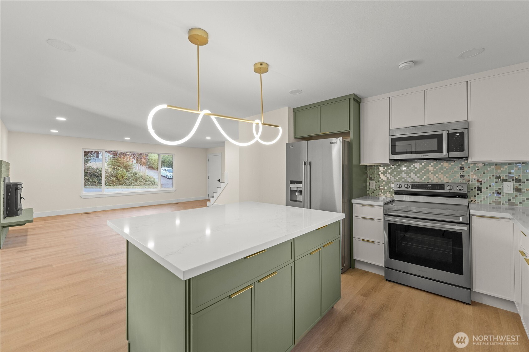 29628 22nd Avenue South Federal Way, WA 98003 - Photo 11 of 40 a kitchen with stainless steel appliances granite countertop a sink a stove a refrigerator and island