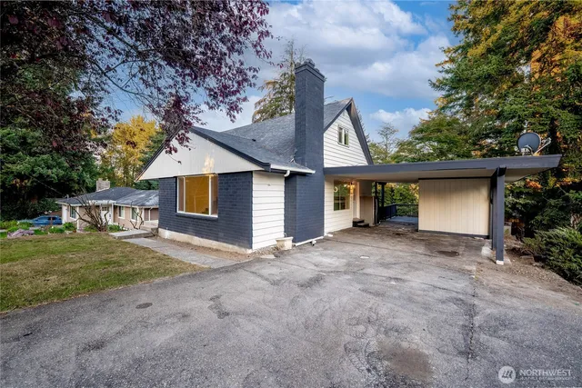 a view of a house with a yard and garage