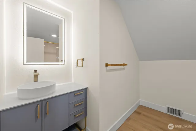 a bathroom with a sink and a mirror