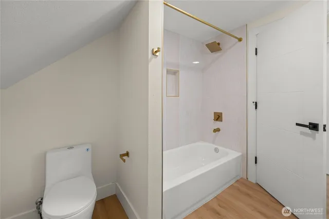 a bathroom with a bathtub and toilet