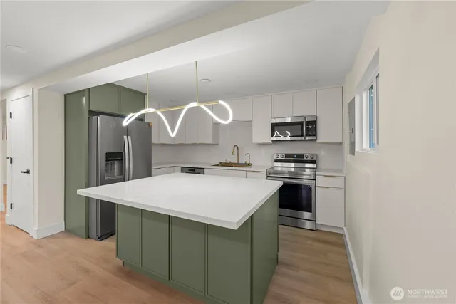 a kitchen with a stove a sink and a refrigerator