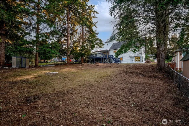a view of a house with a yard and trees