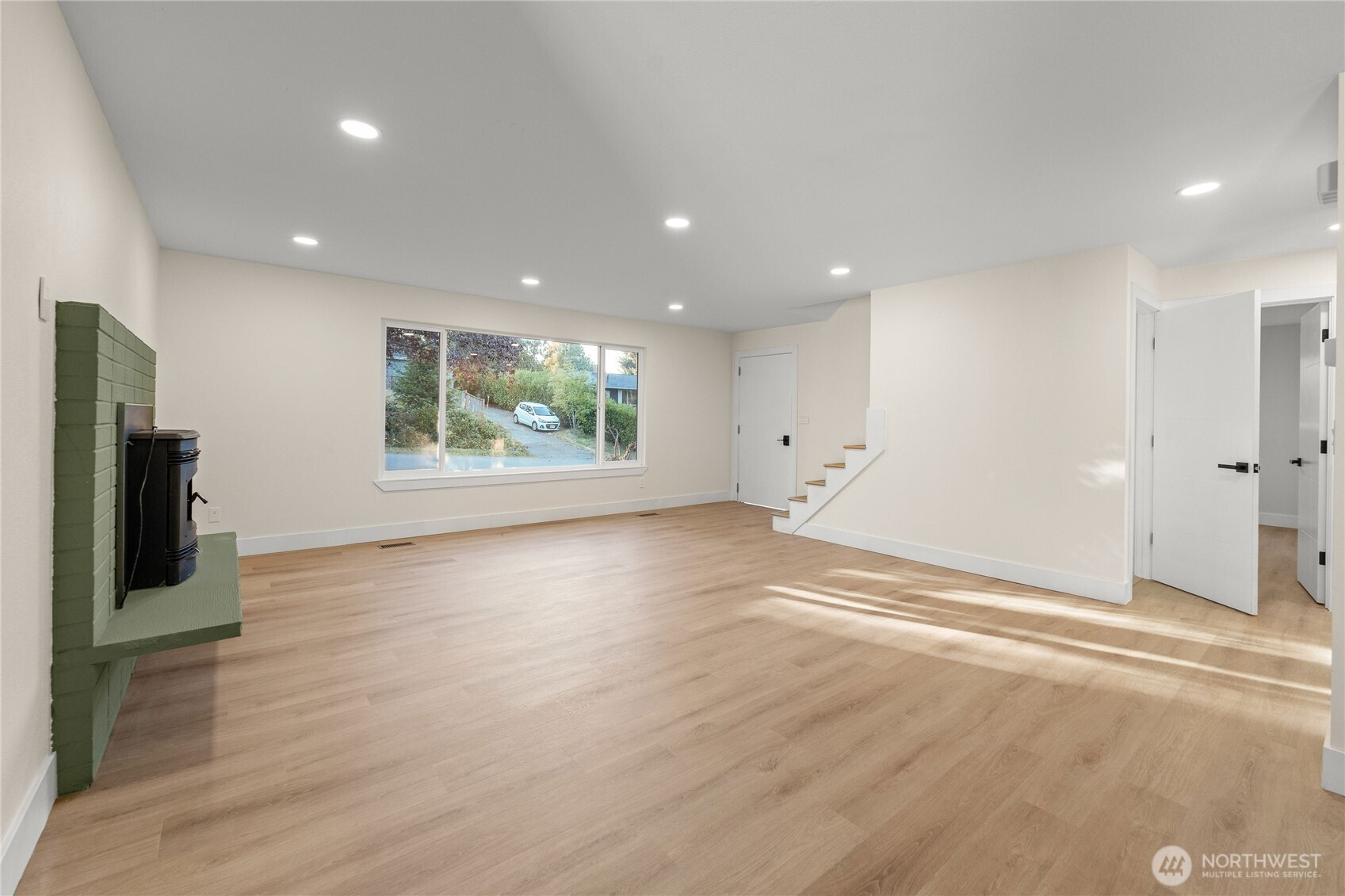 29628 22nd Avenue South Federal Way, WA 98003 - Photo 7 of 40 a view of an empty room with wooden floor and a window