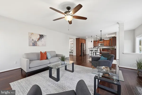 a living room with fireplace furniture and a wooden floor