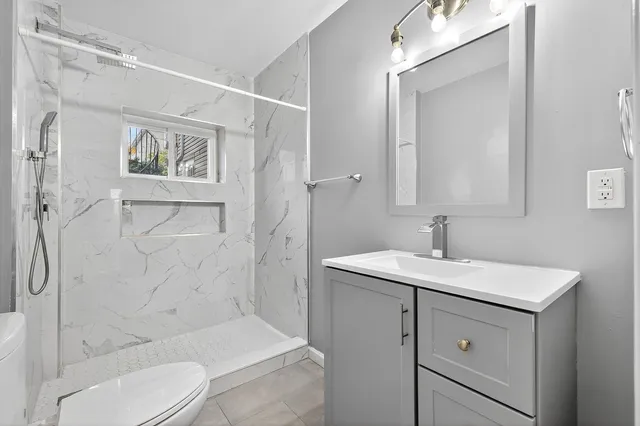 a bathroom with a sink toilet and shower