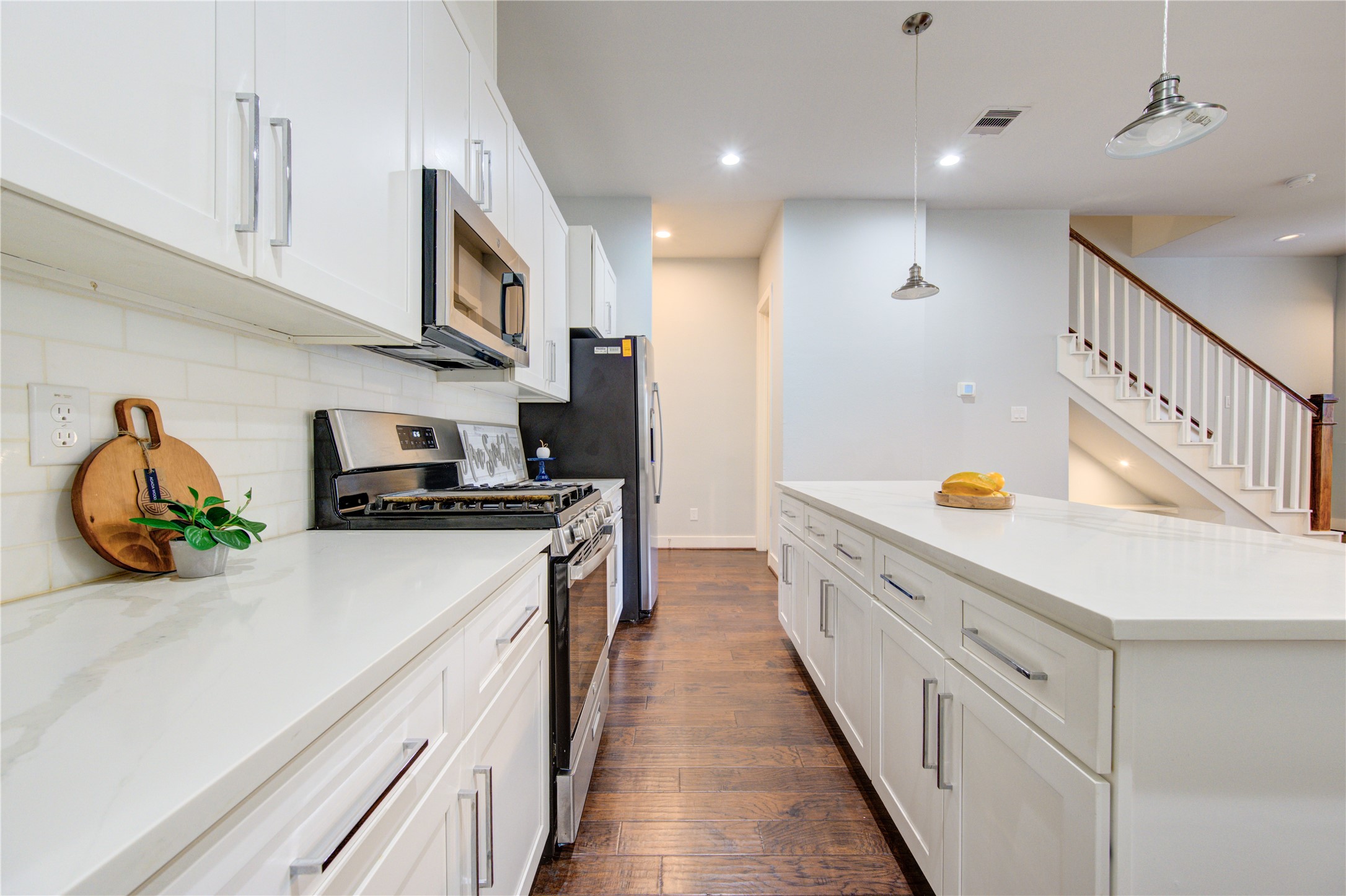847 Rachel Street, Unit G Houston, TX 77091 - Photo 2 of 42 Quartz countertops, a spacious island, modern appliances, and sleek finishes combine to create a modern luxury living space.