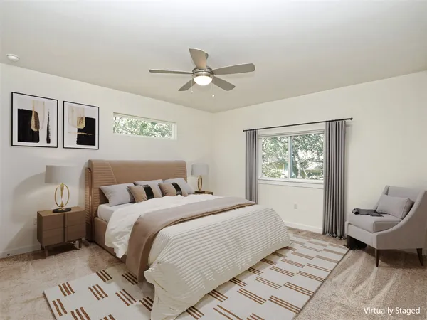 a bedroom with a large bed and a window