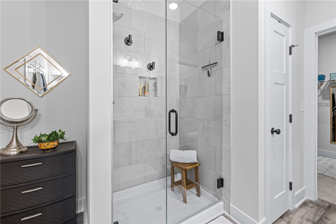 135 Bowers Estates Road Hartwell, GA 30643 - Photo 19 of 35 This modern bathroom features a spacious walk-in shower with sleek finishes, offering a refreshing retreat.