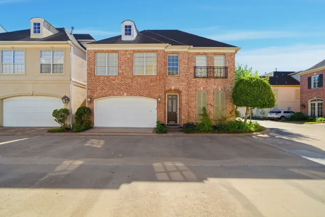 a front view of a house with a yard and a garage