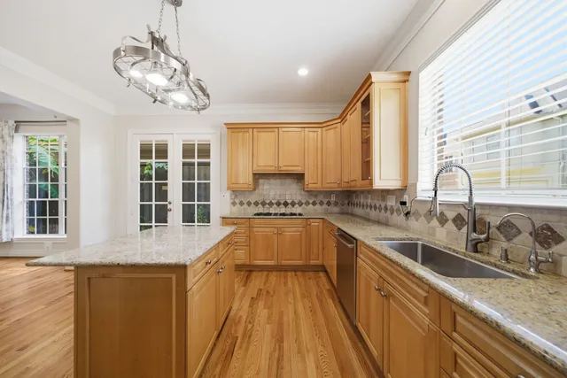 a kitchen with stainless steel appliances granite countertop a sink stove and cabinets