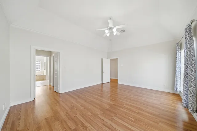 a view of an empty room with wooden floor