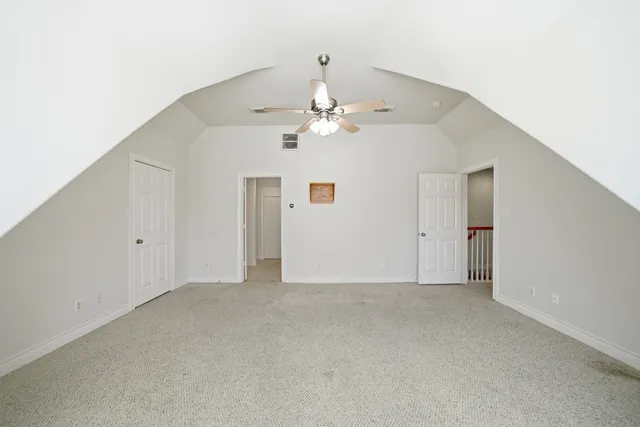 a view of a big room with chandelier fan