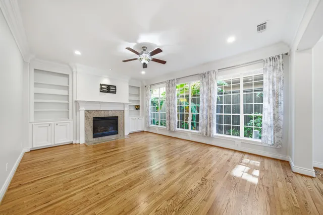 a view of empty room with wooden floor and fireplace