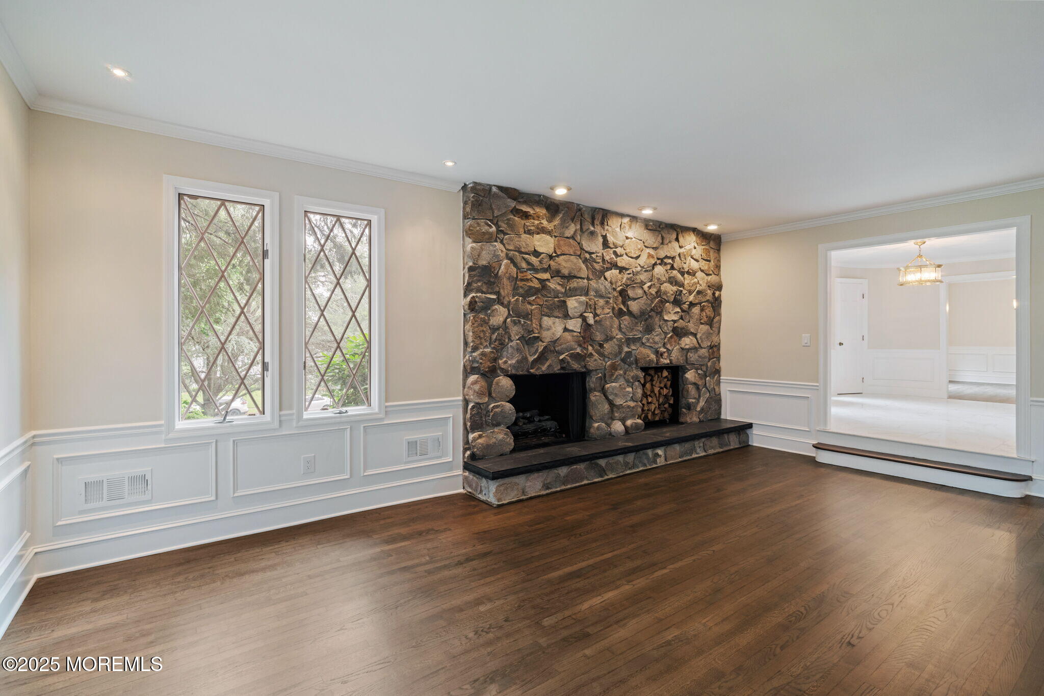 245 Borden Road Middletown, NJ 07748 - Photo 15 of 72 an empty room with wooden floor fire place and windows