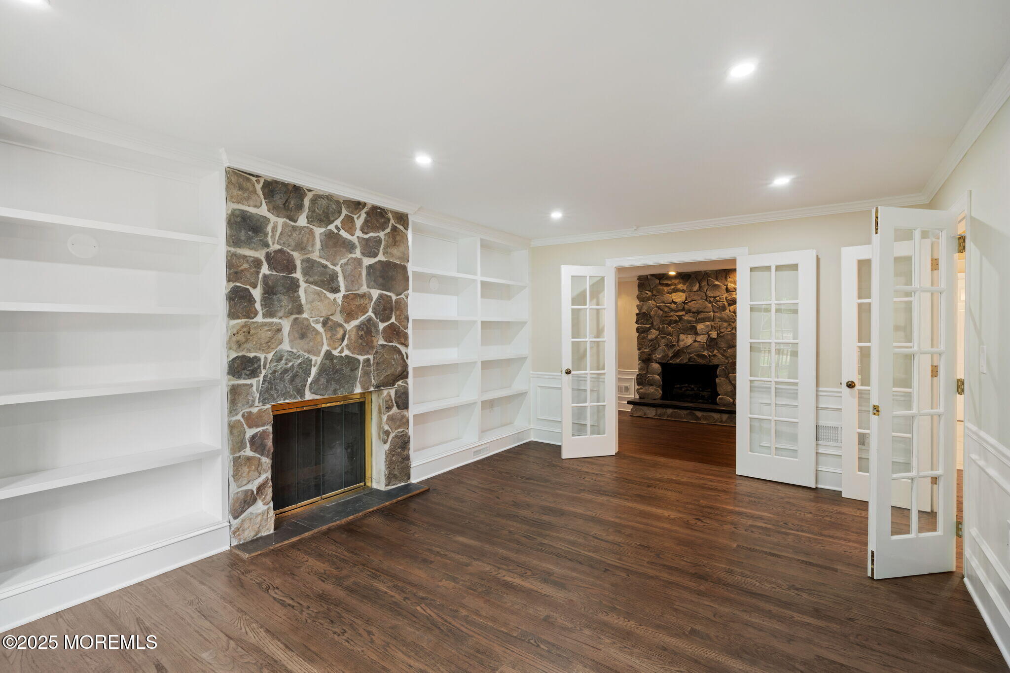 245 Borden Road Middletown, NJ 07748 - Photo 18 of 72 a view of an empty room with a fireplace and wooden floor