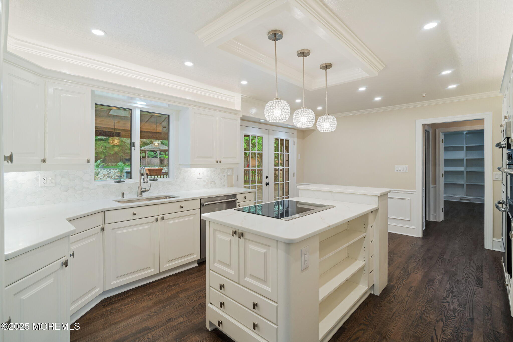 245 Borden Road Middletown, NJ 07748 - Photo 27 of 72 a kitchen with a sink chandelier and wooden floor