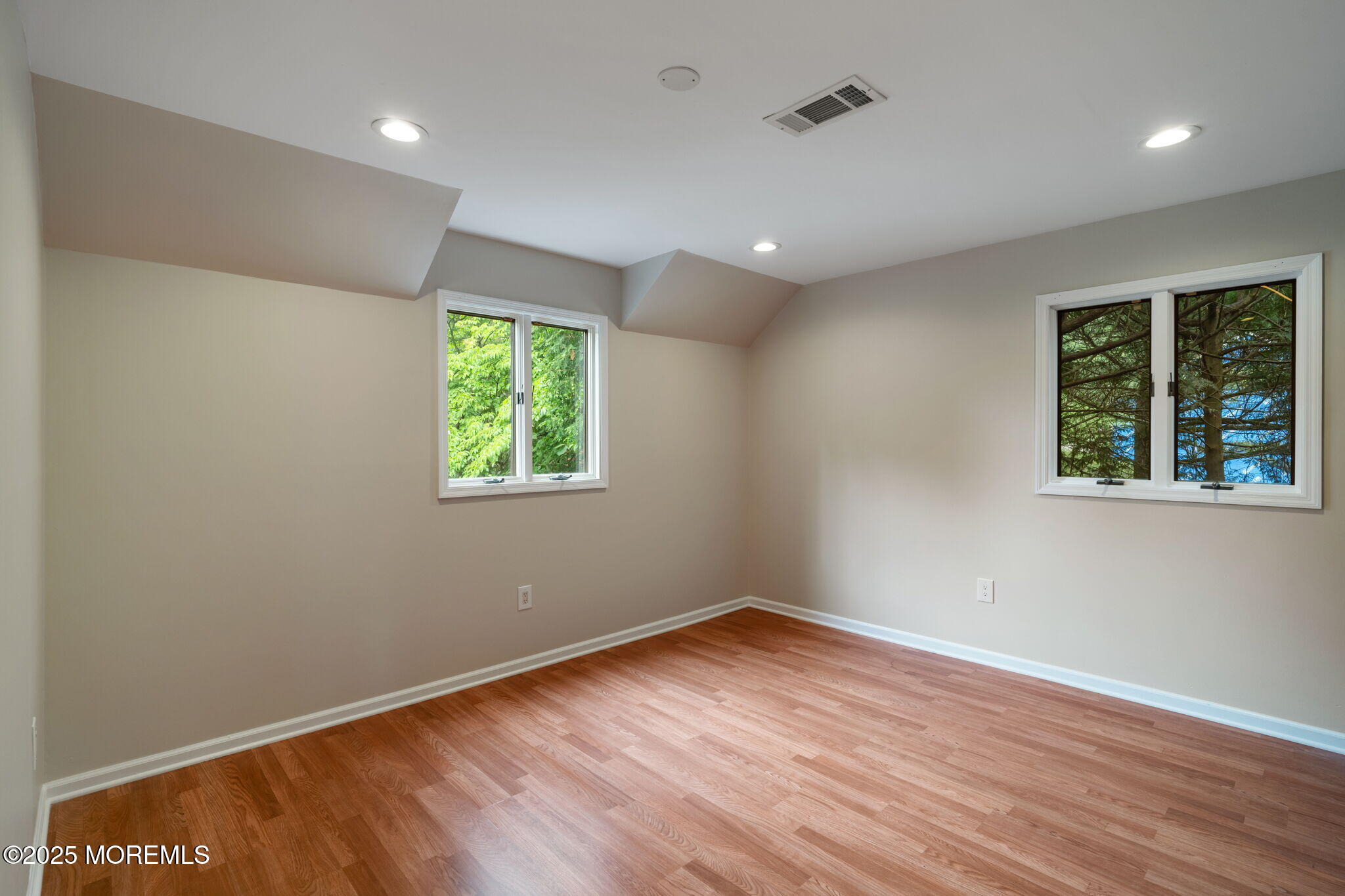 245 Borden Road Middletown, NJ 07748 - Photo 39 of 72 an empty room with wooden floor and windows
