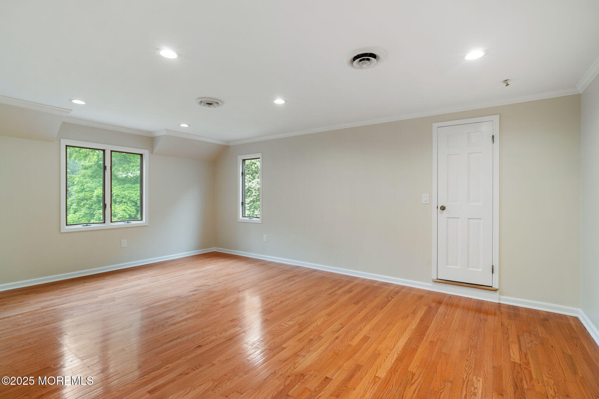 245 Borden Road Middletown, NJ 07748 - Photo 46 of 72 an empty room with wooden floor and windows