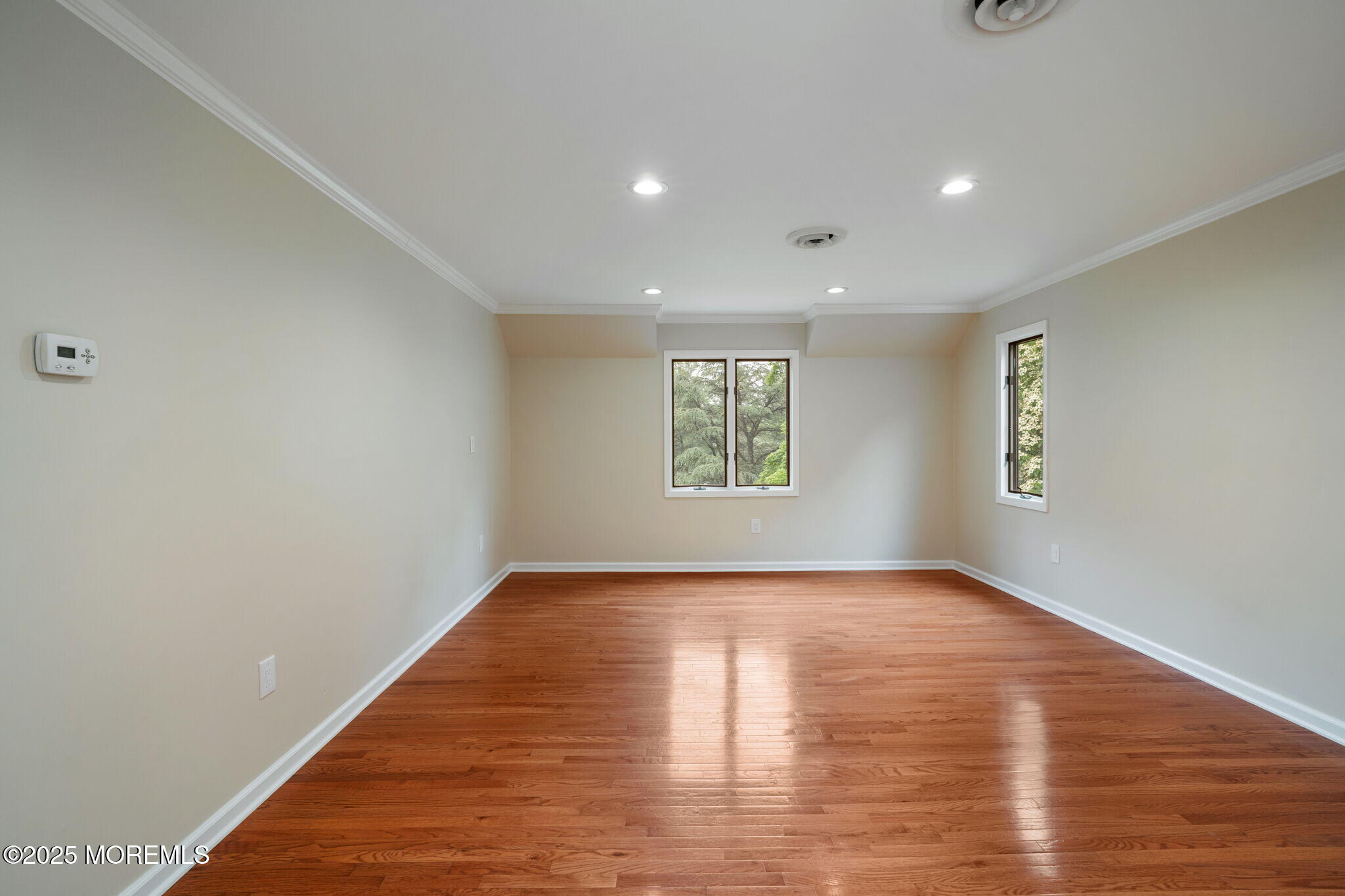 245 Borden Road Middletown, NJ 07748 - Photo 47 of 72 a view of an empty room with a window and wooden floor