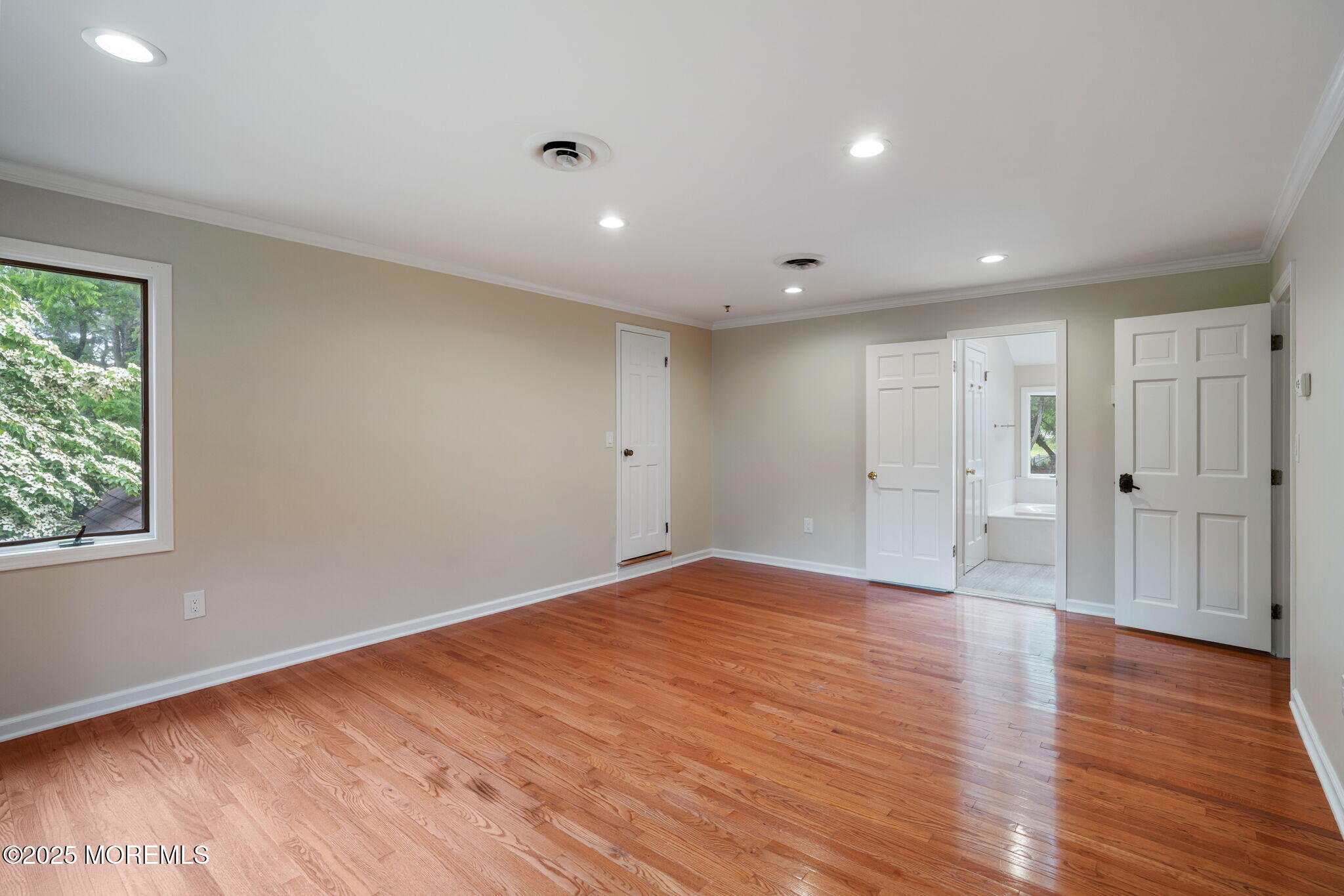 245 Borden Road Middletown, NJ 07748 - Photo 48 of 72 a view of an empty room with wooden floor and windows