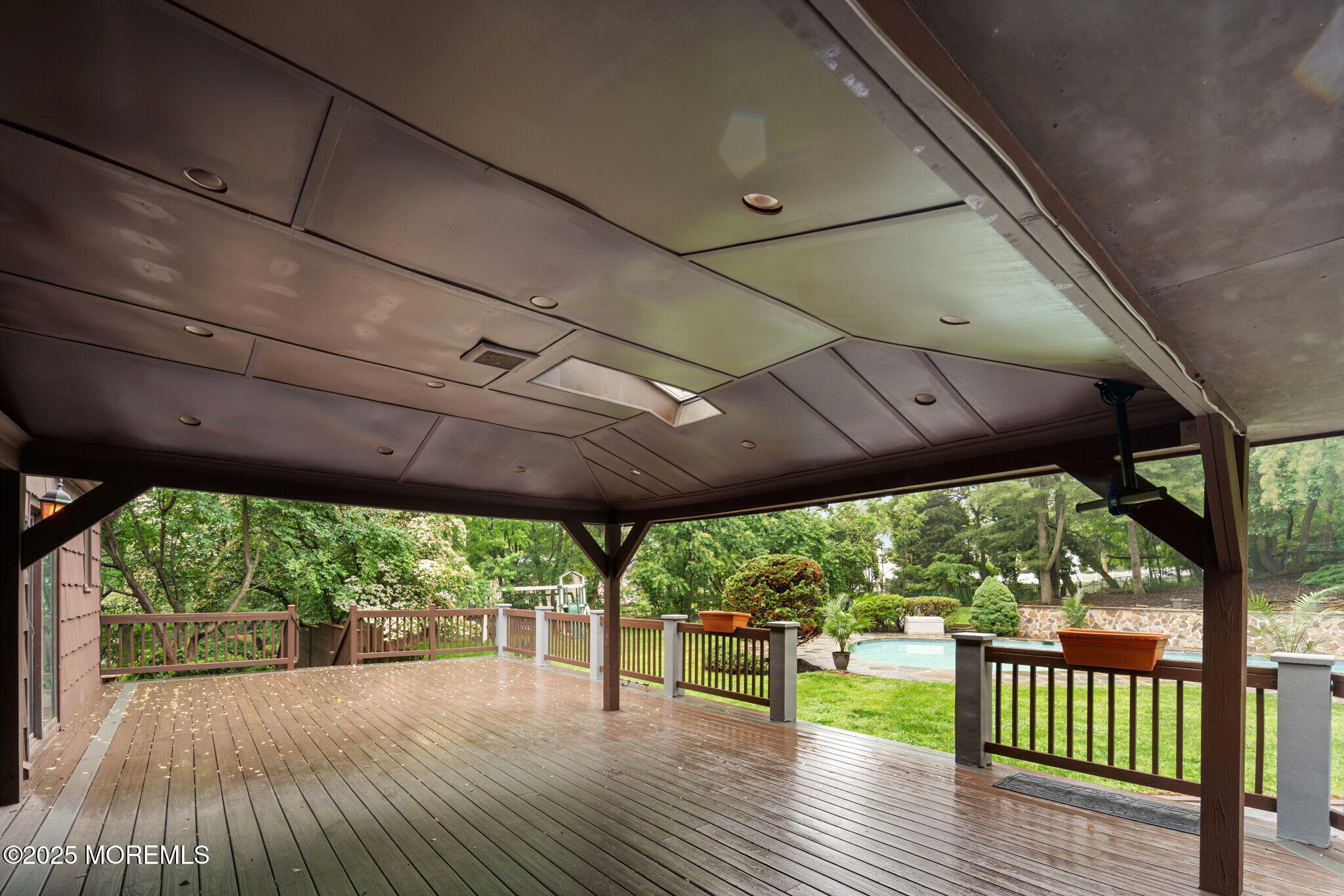 245 Borden Road Middletown, NJ 07748 - Photo 60 of 72 a patio with wooden floor a yard tables and chairs