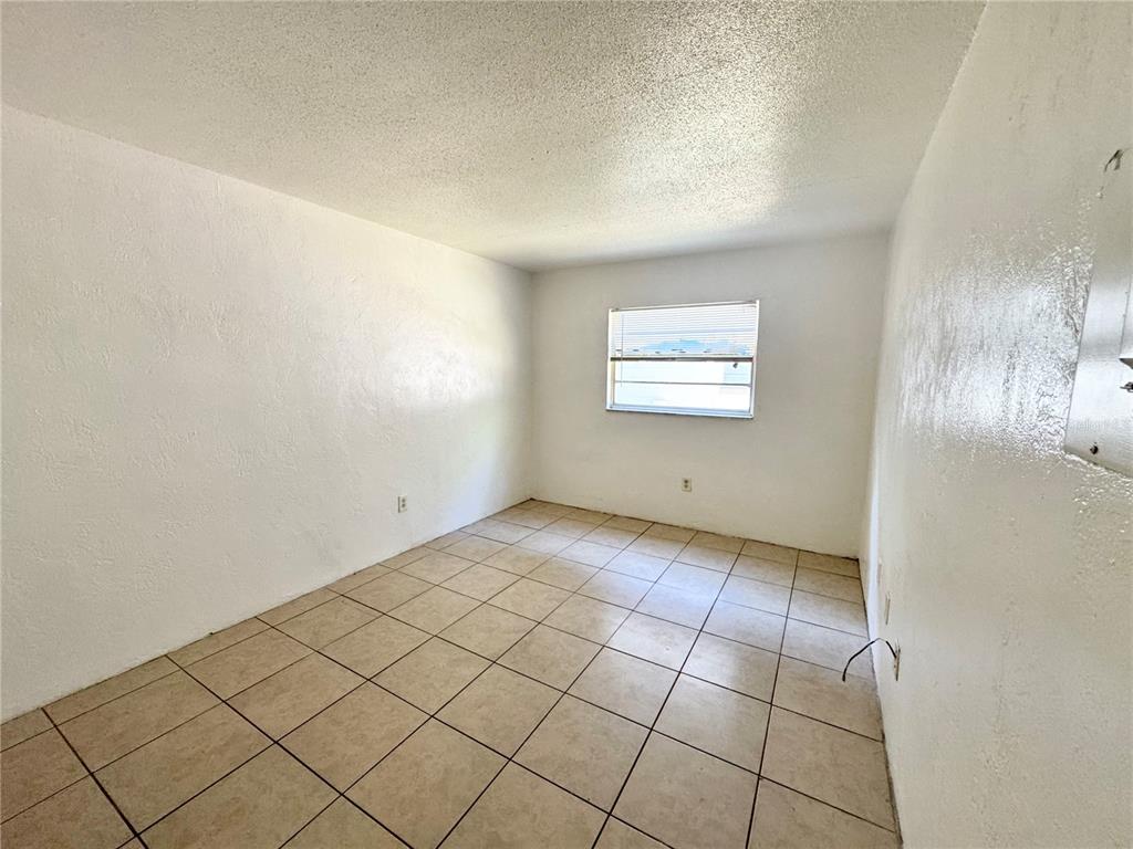 1229 Kennedy Road, Unit 43 Daytona Beach, FL 32117 - Photo 6 of 9 an empty room with windows