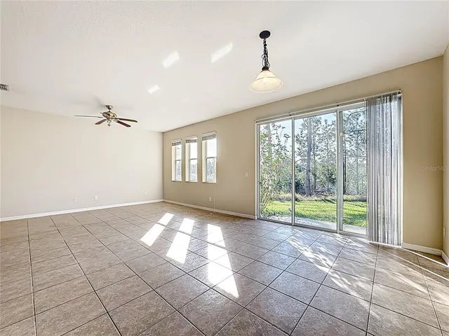 a view of a room with window and a ceiling fan