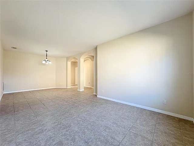 a kitchen with kitchen island granite countertop a stove sink and microwave