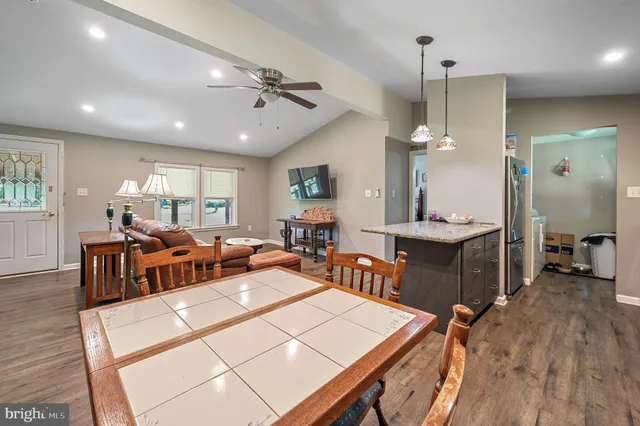 a living room with lots of furniture and kitchen view