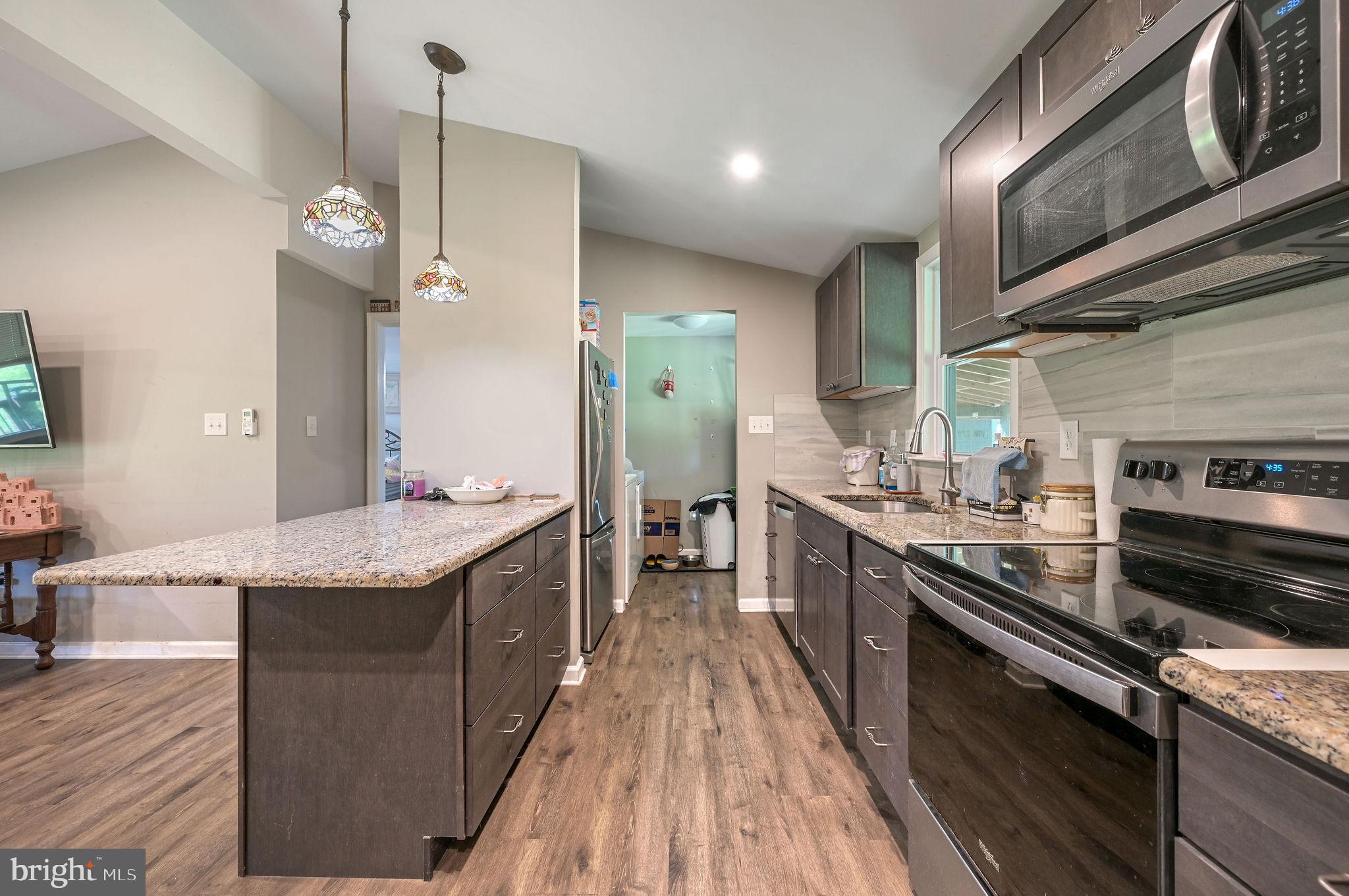 2821 Sandtown Road Felton, DE 19943 - Photo 18 of 26 a kitchen with stainless steel appliances granite countertop counter space a sink and cabinets