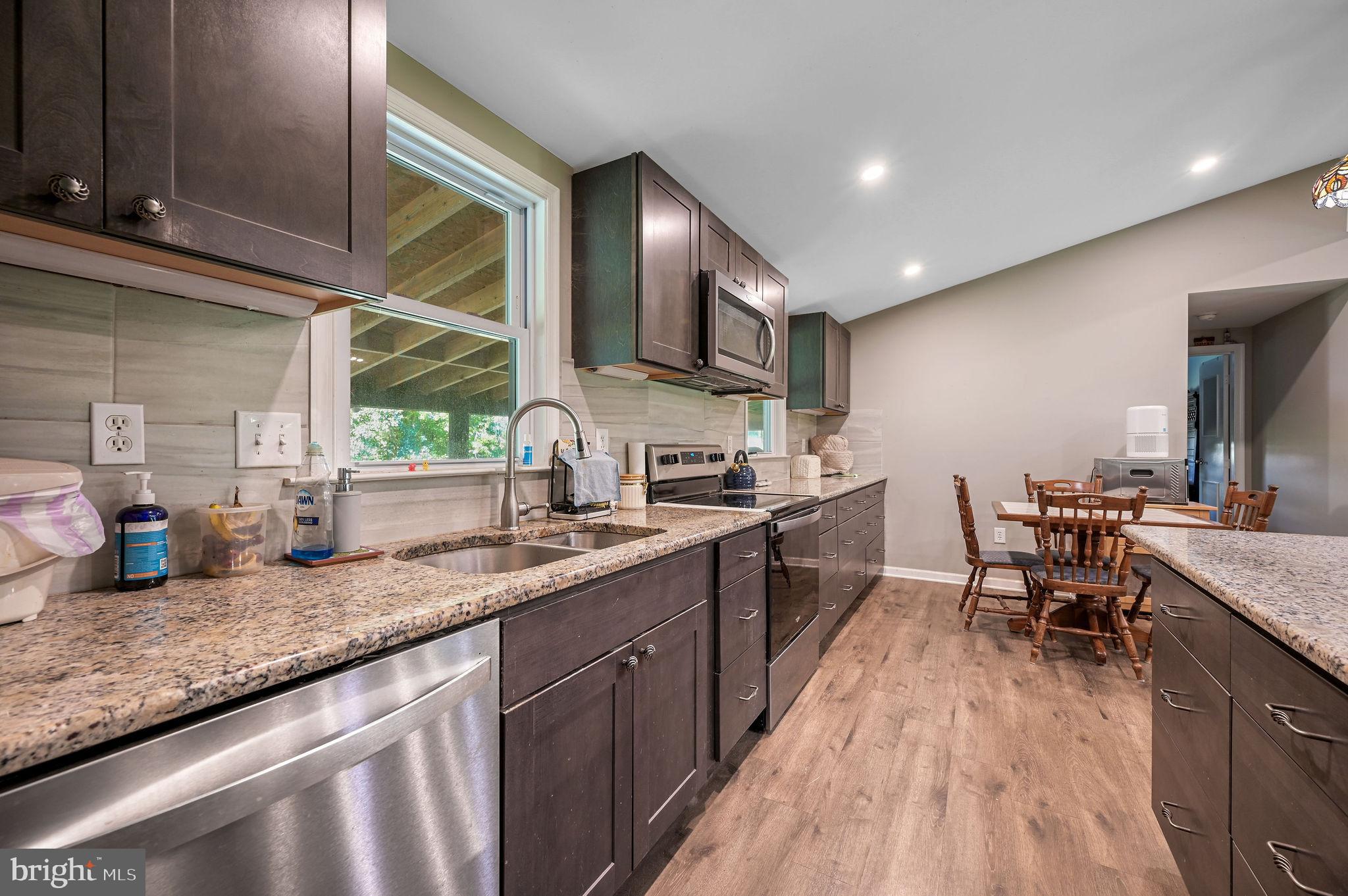 2821 Sandtown Road Felton, DE 19943 - Photo 19 of 26 a kitchen with lots of counter top space and dining table