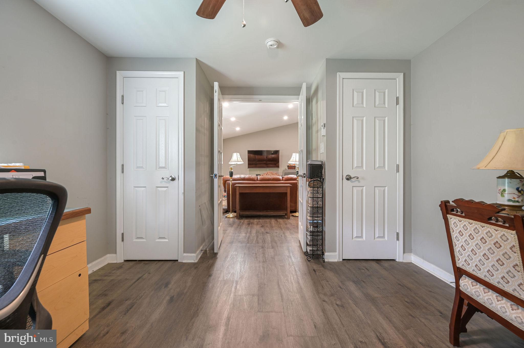 2821 Sandtown Road Felton, DE 19943 - Photo 21 of 26 a view of a hallway with wooden floor and furniture
