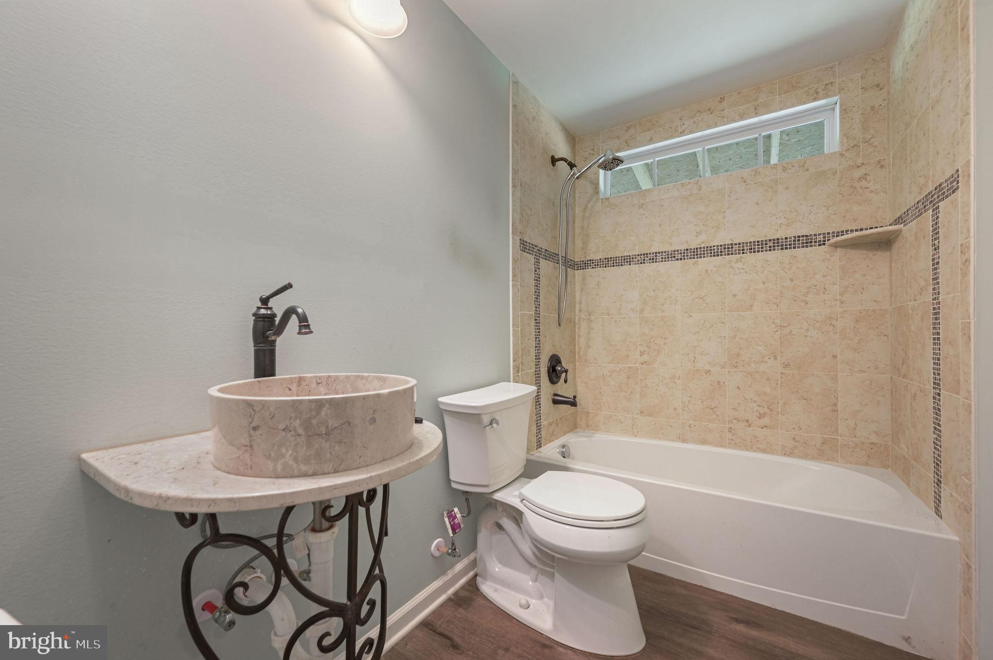 2821 Sandtown Road Felton, DE 19943 - Photo 22 of 26 a bathroom with a toilet a sink and a bathtub