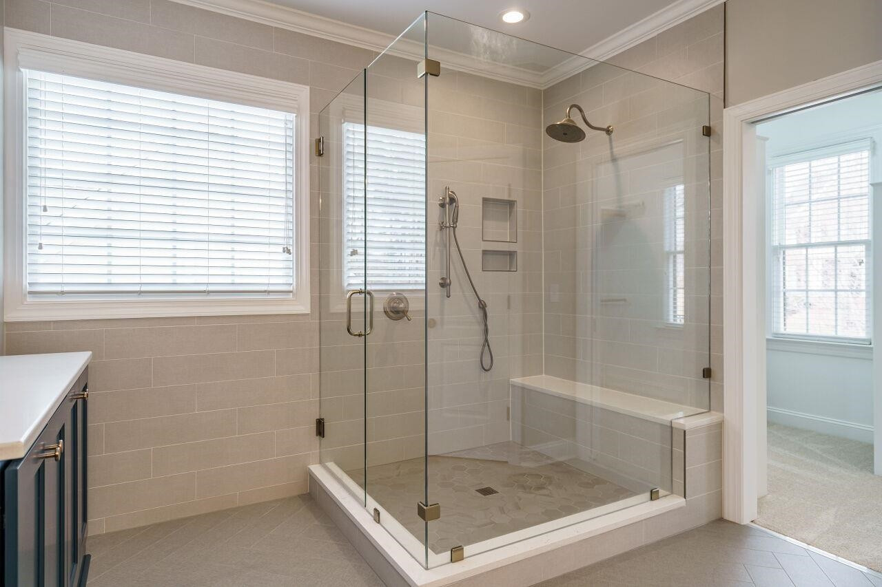 5327 Landguard Drive Raleigh, NC 27613 - Photo 26 of 45 Renovated, gorgeous owner's spa! Dual vanities, herringbone patterned floor tile, glass enclosed shower and water closet! Owner's Suite