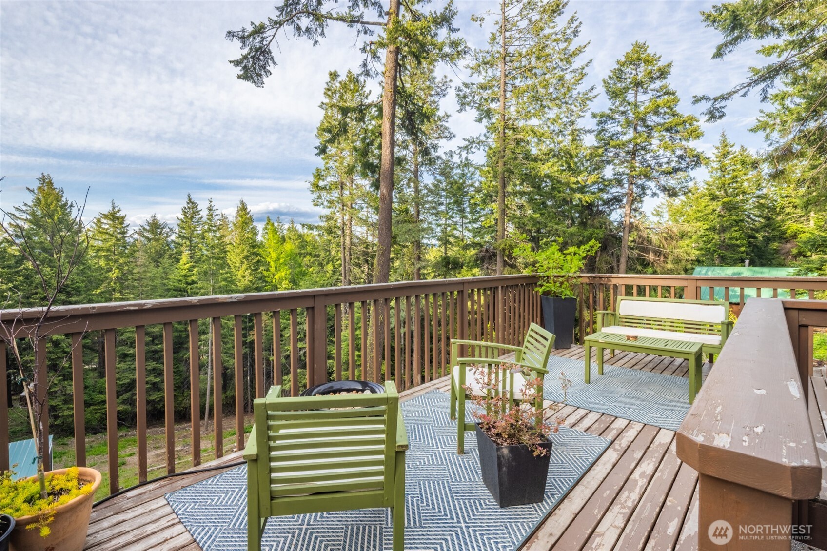 451 Aspen Springs Road Cle Elum, WA 98922 - Photo 2 of 27 a view of a balcony with wooden floor and outdoor seating