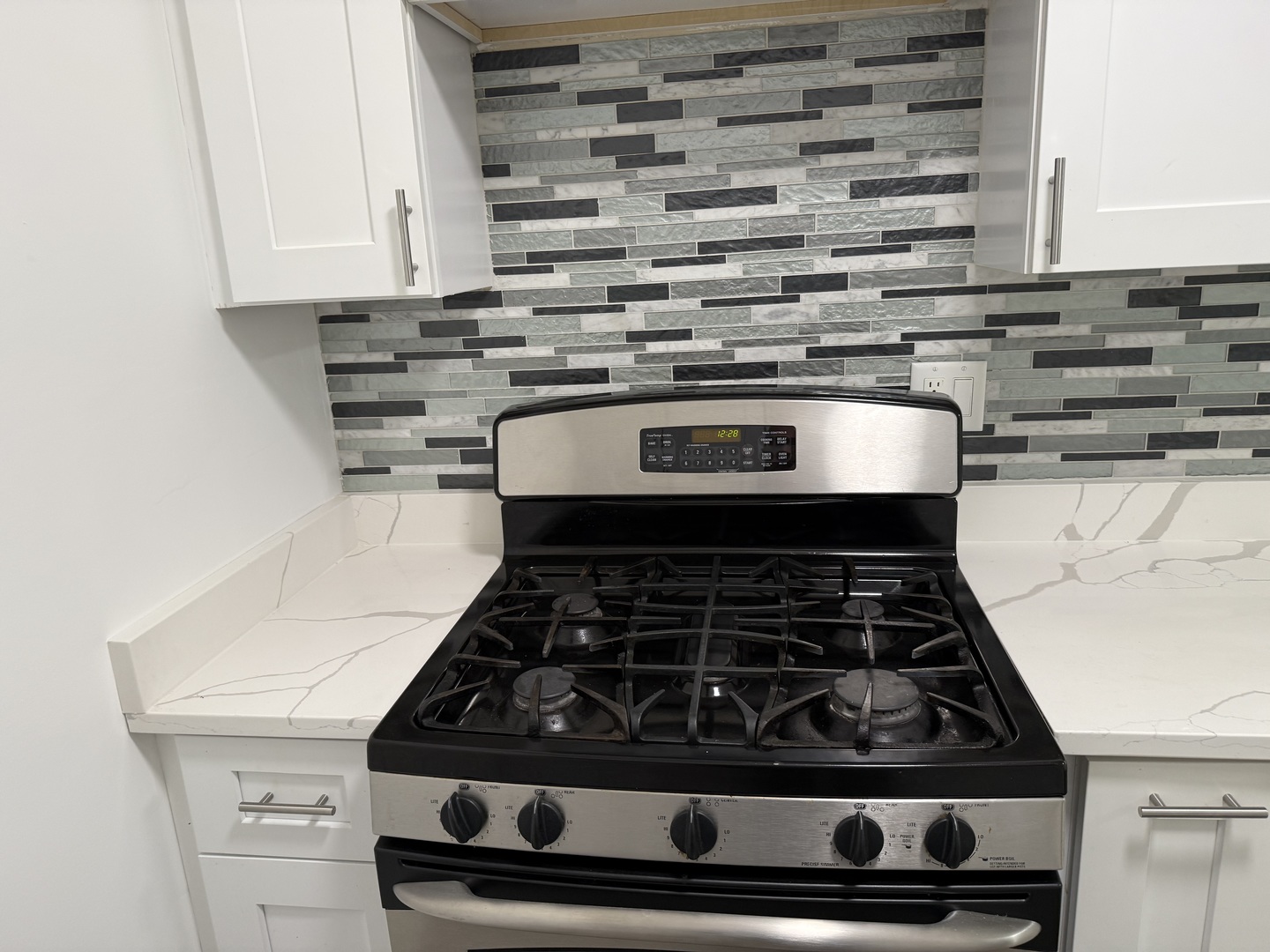 16W525 Mockingbird Lane, Unit 102 Willowbrook, IL 60527 - Photo 13 of 25 a stove top oven sitting inside of a kitchen