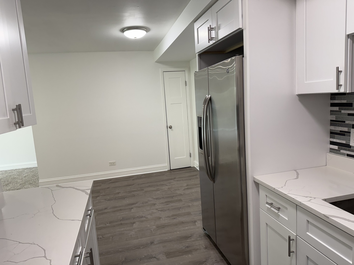 16W525 Mockingbird Lane, Unit 102 Willowbrook, IL 60527 - Photo 17 of 25 a kitchen with granite countertop a refrigerator and a stove top oven