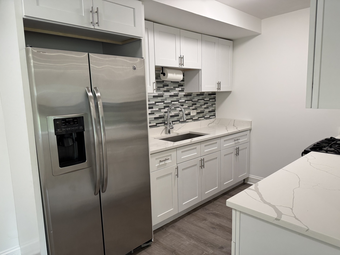 16W525 Mockingbird Lane, Unit 102 Willowbrook, IL 60527 - Photo 10 of 25 a kitchen with a refrigerator sink and cabinets