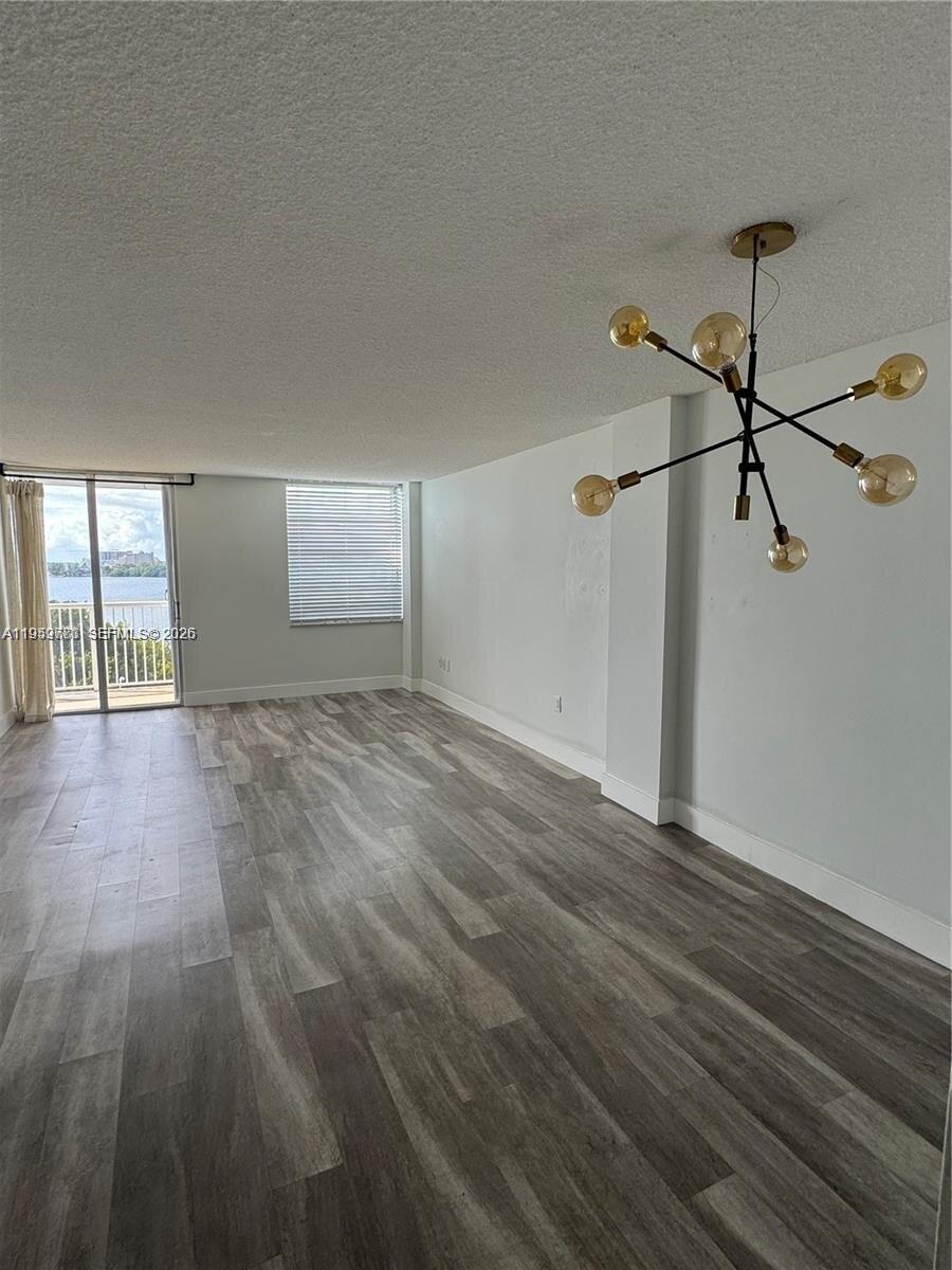 150 Southeast 25th Road, Unit 8L Miami, FL 33129 - Photo 4 of 5 a view of empty room with wooden floor and fan