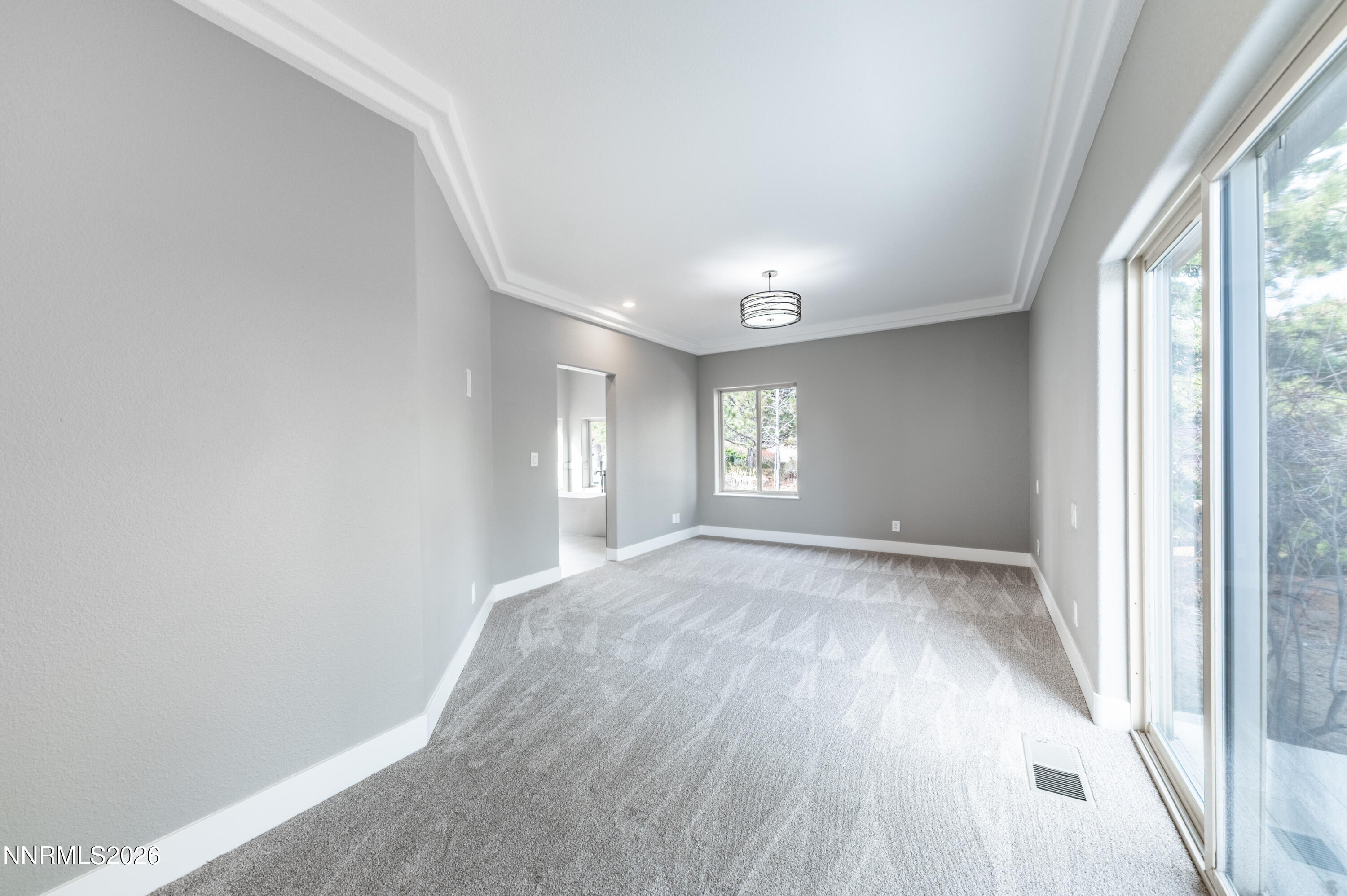14330 East Windriver Lane Reno, NV 89511 - Photo 22 of 36 a view of empty room with wooden floor and fan