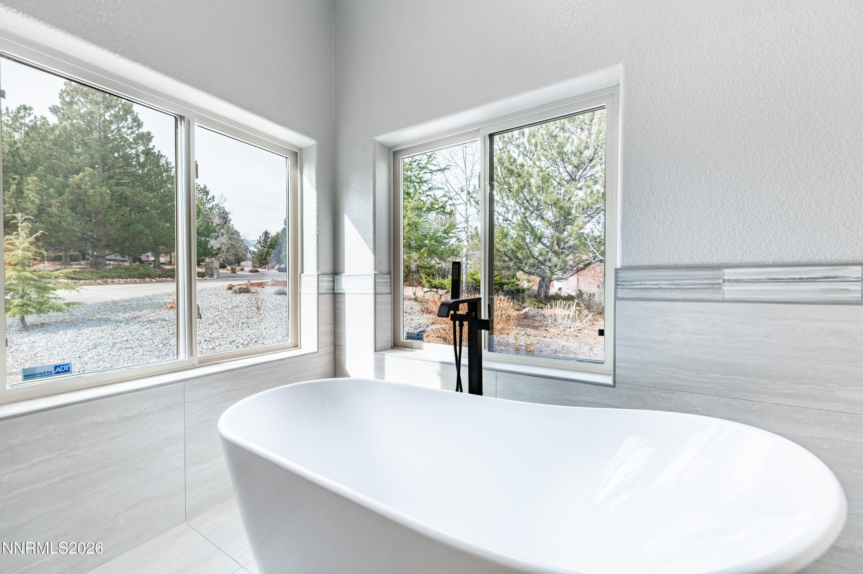 14330 East Windriver Lane Reno, NV 89511 - Photo 26 of 36 a living room with a large window and a table