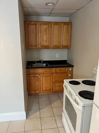 a kitchen with a stove top oven and cabinets