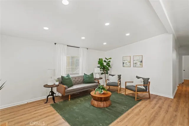 a living room with furniture and a potted plant